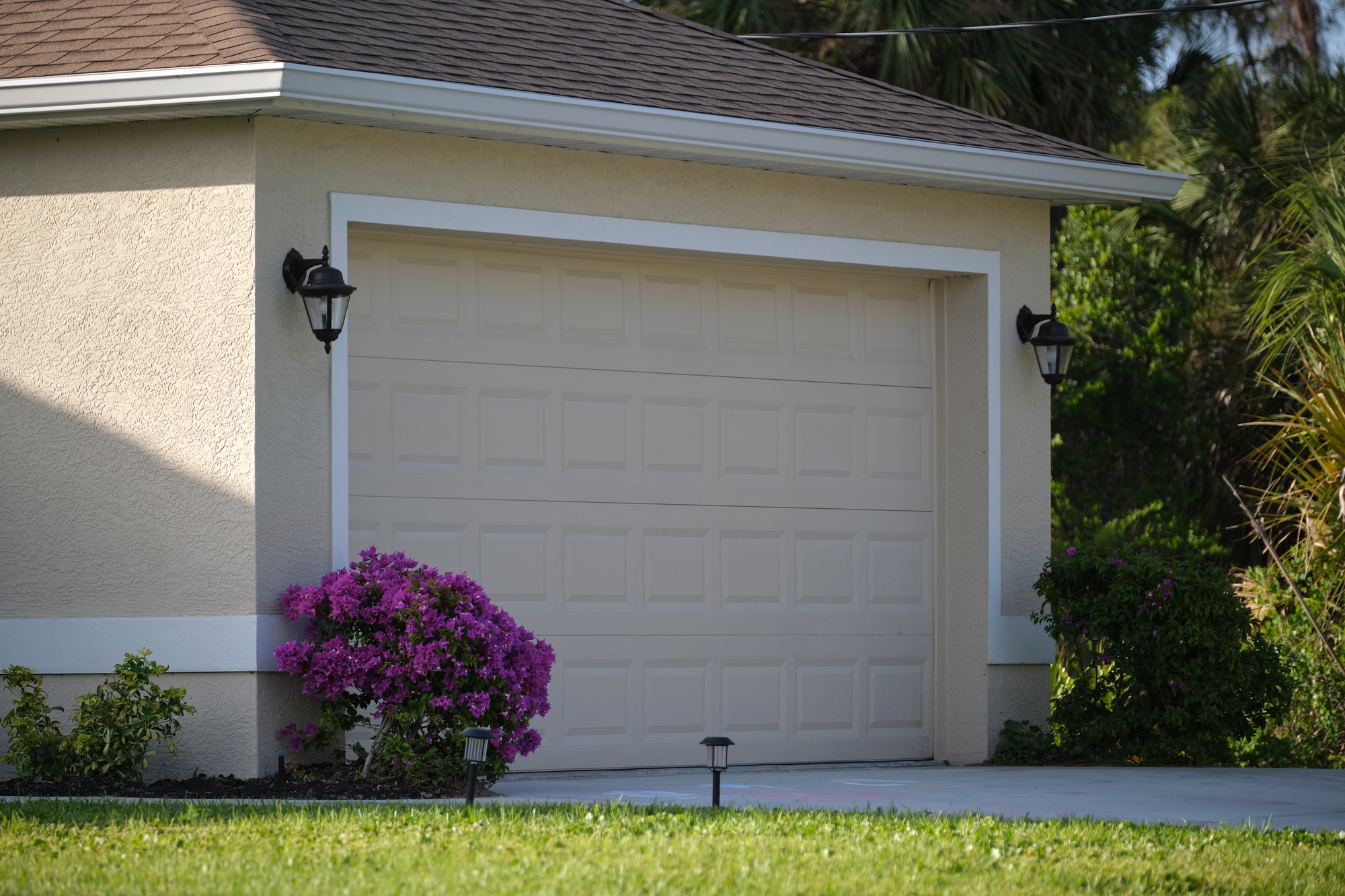wide-garage-double-door-and-concrete-driveway-of-new-modern-american-house-3