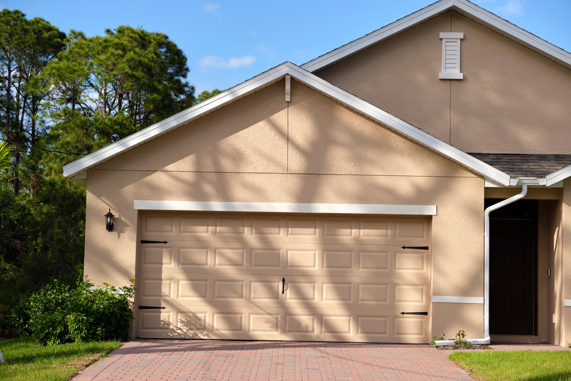 wide-garage-double-door-and-concrete-driveway-of-new-modern-american-house-6